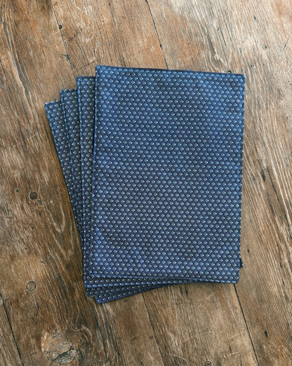 Blue ShweShwe Fabric placemats with White Diamond print on wooden table.