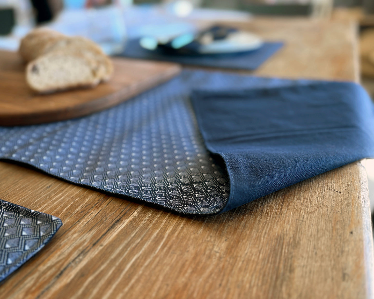 Navy Shwe Shwe lined fabric Table runner on wooden table. Diamond print on fabric.