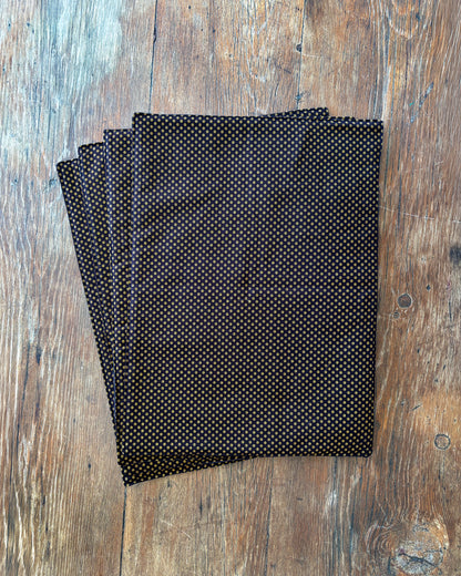 Brown Shwe Shwe Fabric placemats with White & Yellow Dots print on wooden table.