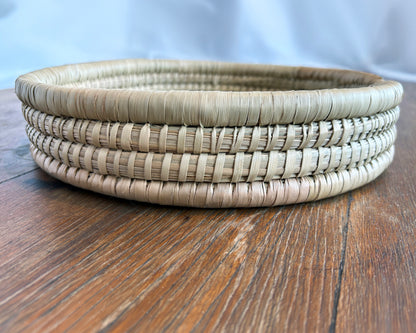 Round Woven tray on a wooden surface - close up of texture