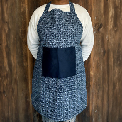 Person wearing a blue patterned Shwe Shwe apron with blue front pocket